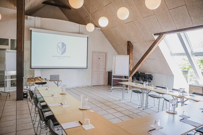 Moderne mødelokale med U-opstilling, projektor og ovenlys – professionelle konferencefaciliteter på Sonnerupgaard Gods